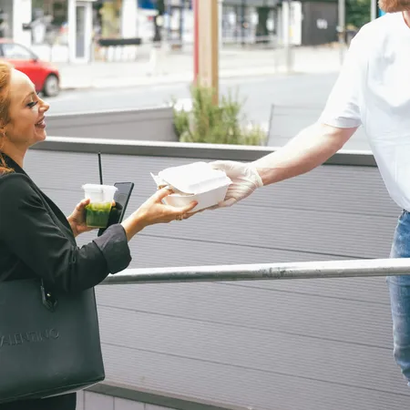 Photo of a happy customer purchasing lunch from a trusted vendor